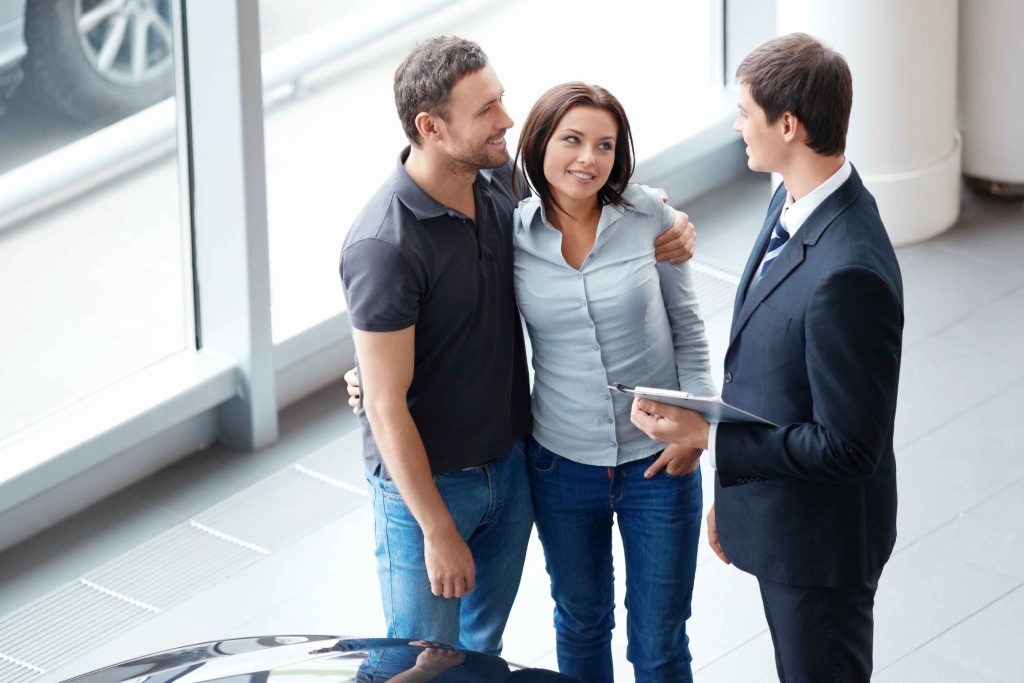 Couple at a Car Dealership